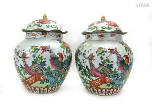 A pair of Chinese covered vases of squat ovoid form decorated in coloured enamels with exotic birds,