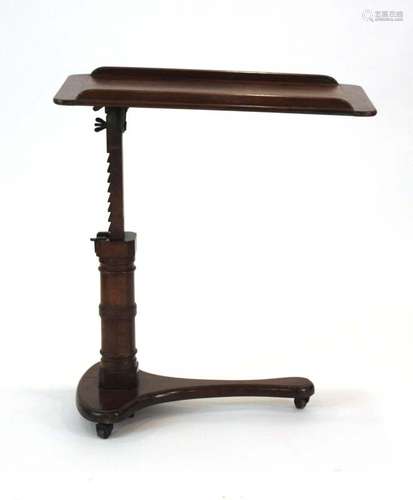 A Victorian mahogany adjustable reading table on a turned shaft and platform base,