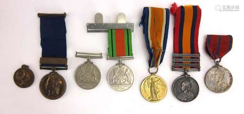 A group of cap badges and medals including two Second World War defence medals,