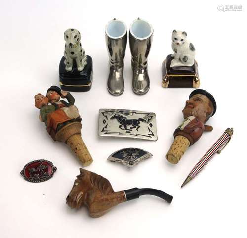 A group of collectables including a polychrome bottle stopper, a pair of boots, a carved pipe,