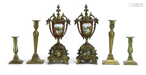 A pair of gilt brass and porcelain garnitures together with two pairs of brass candlesticks