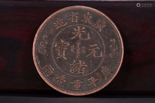 A BRONZE COIN WITH 