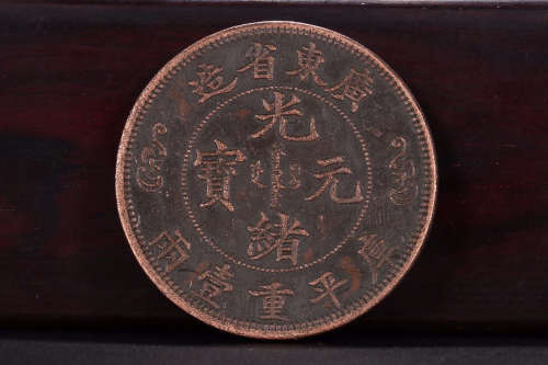A BRONZE COIN WITH 