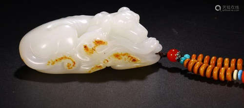 A HETIAN SEED JADE AUSPICIOUS BEAST SHAPED PENDANT