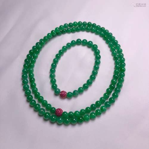 A JADEITE NECKLACE WITH TWO 18K GOLD RED RUBY BEADS