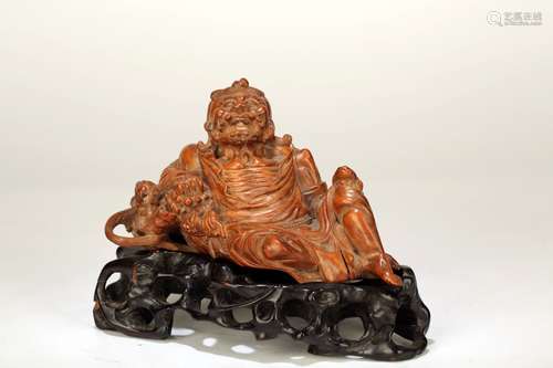 A HUANGYANG WOOD ORNAMENT OF AN OLD MAN