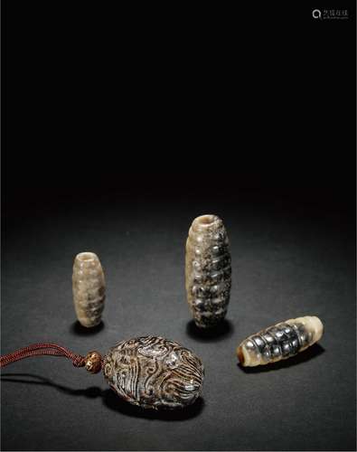 汉·蚕形玉勒及兽纹玉勒一组四件 HAN DYNASTY  A JADE 'SILKWORM' PENDANT AND A JADE PENDANT WITH BEAST PATTERN