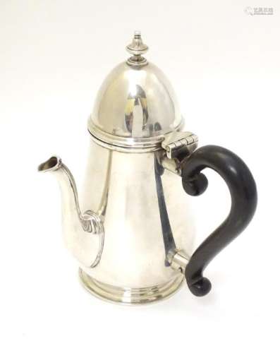 A silver chocolate pot with ebonised handle hallmarked