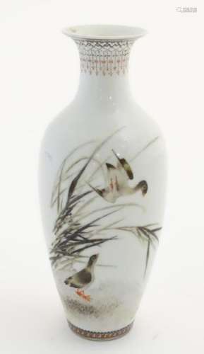 A small Oriental baluster vase, decorated with wader
