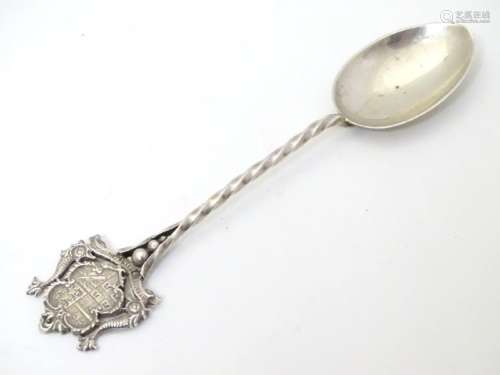 A silver souvenir spoon with crest to handle titled