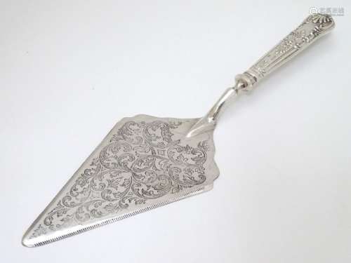 A silver handled pastry server. 11 1/2'' long