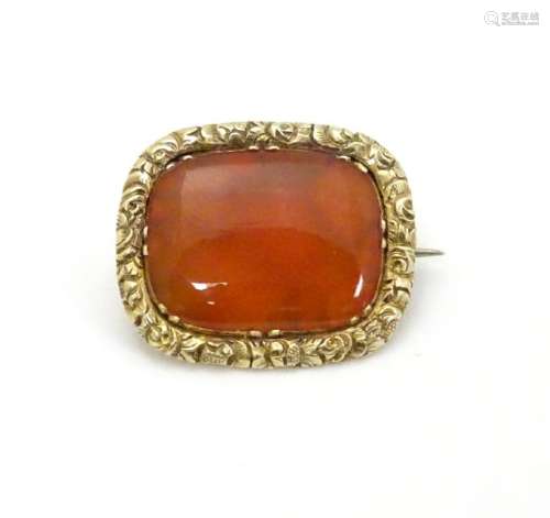 A 19thC brooch set with central carnelian within an