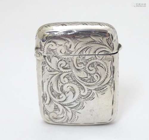A silver vesta case with engraved decoration hallmarked