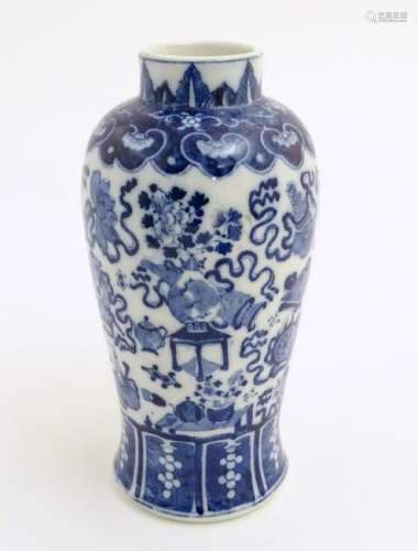 A Chinese blue and white vase decorated with emblems of