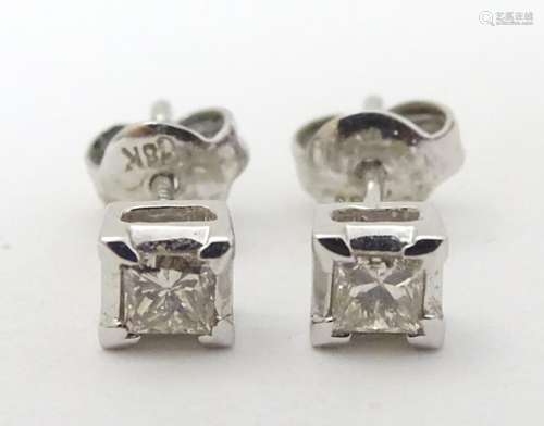 A pair 18ct white gold diamond solitaire earrings. Each