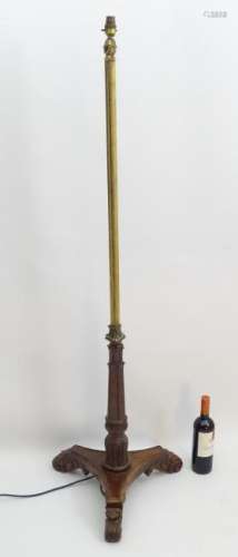 A rosewood tripod standard lamp with acanthus feet and