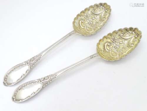 A pair of embossed silver berry spoons hallmarked