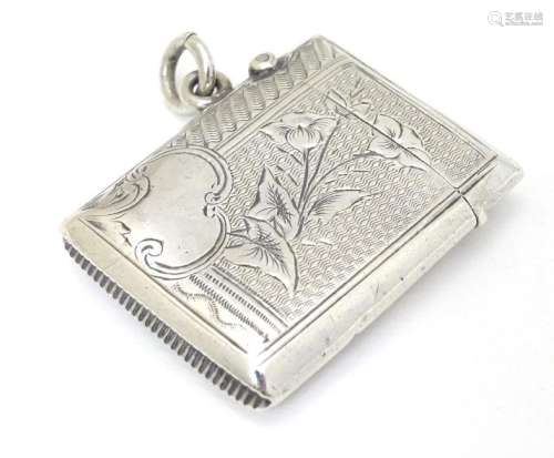 A silver vesta case with engraved decoration.
