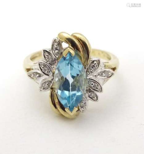 A 9ct gold ring set with central marquise cut topaz