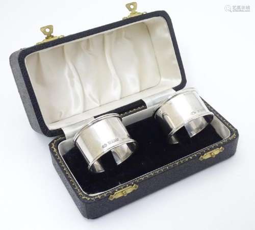 A cased pair of silver napkin rings hallmarked