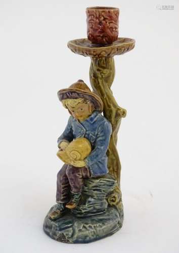 A continental candlestick decorated with a fisherman