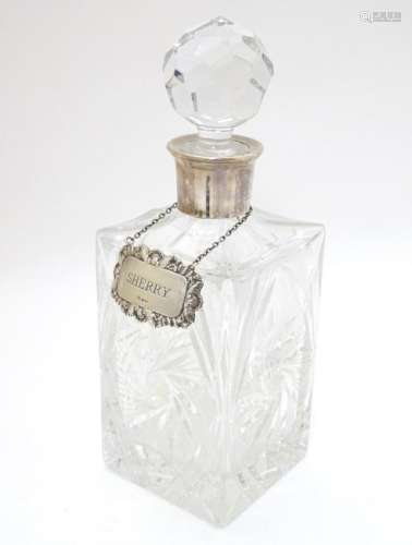 A cut lead crystal decanter of squared form with silver