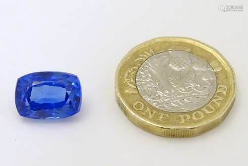 Unmounted stone: A blue cushion cut sapphire. Approx