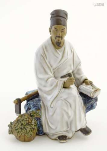 A Chinese partially glazed ceramic mudman figurine