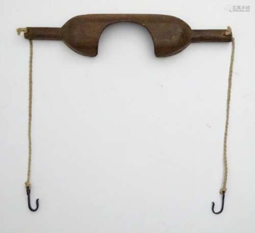 An 18thC/19thC yoke with chains terminating in hooks,