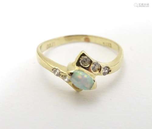 An opal ring set with central opal flaked by white