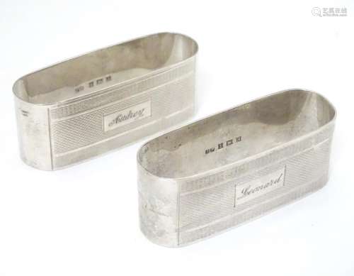 A pair of silver napkin rings with engine turned