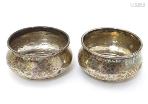 A pair of Art Deco silver salts with hammered