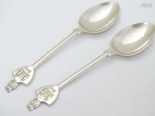 A pair of commemorative silver teaspoons, the handles