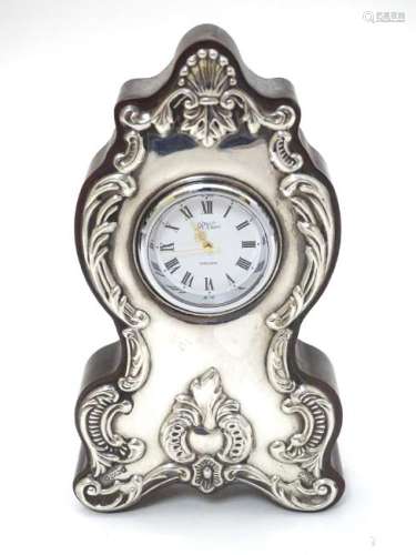 A mantle clock with silver mounts hallmarked Sheffield