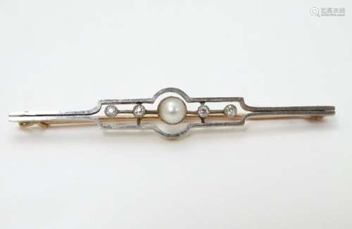 An Art Deco gold brooch set with central pearl flanked
