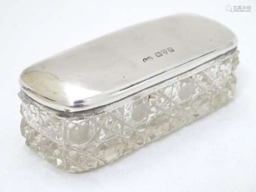 A cut glass dressing table pot with silver top