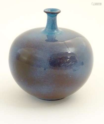 A high fired globular vase with a flared rim. Approx. 9