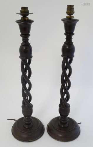 A pair of mid 20thC Walnut triple open twist lampstands