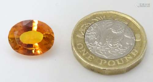 Unmounted stone: An orange oval cut sapphire, approx