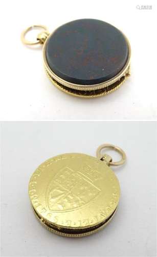 An unsensual gold pendant locket set with Spade Guinea