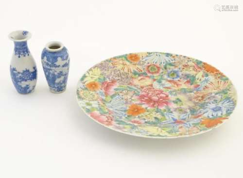 An Oriental plate decorated with stylised flowers, with