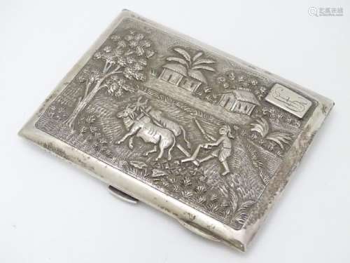 A Sterling silver cigarette case with decoration to lid