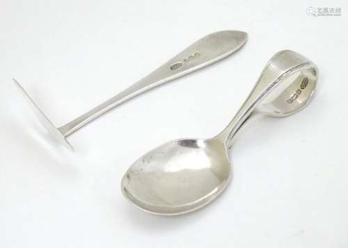 A silver child's spoon and pusher hallmarked 1927 maker