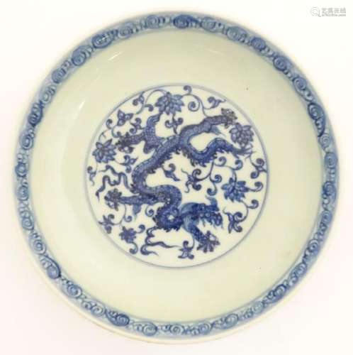 A Chinese blue and white dish decorated with dragons,