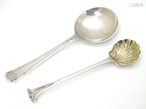 A silver Albany pattern salt spoon with shell formed