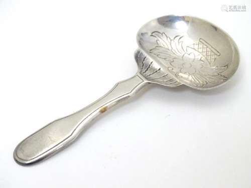 A Portuguese .833 silver tea caddy spoon with engraved