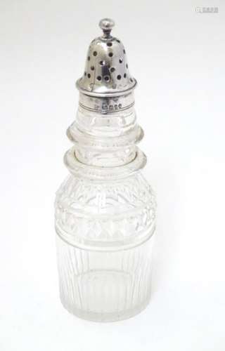 A cut glass pepperette with silver top hallmarked