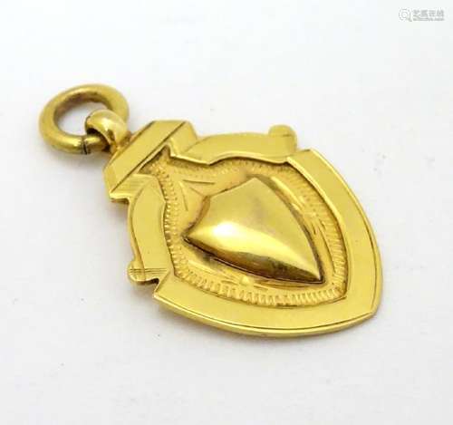 A 9ct gold fob of shield form. approx 1 1/4'' long (4g)