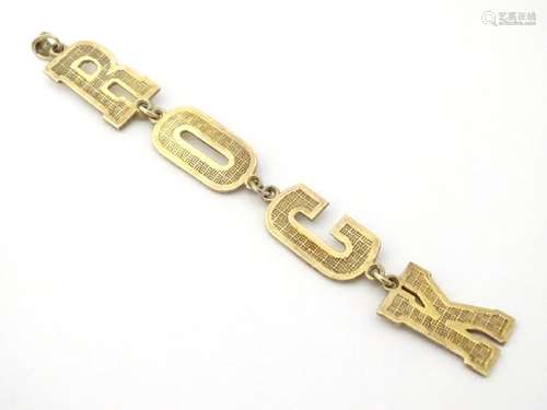 A silver gilt ' ROCK' pedant 3 3/4'' long