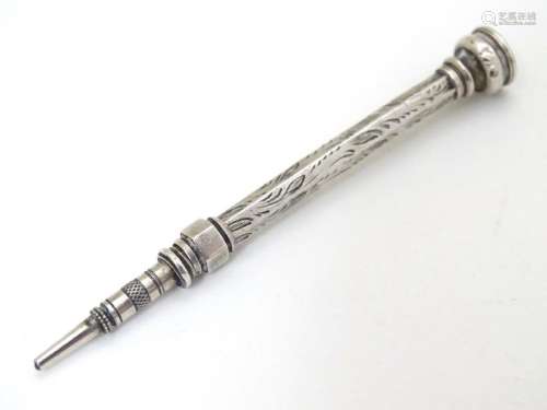 A white metal pencil with amethyst coloured stone to